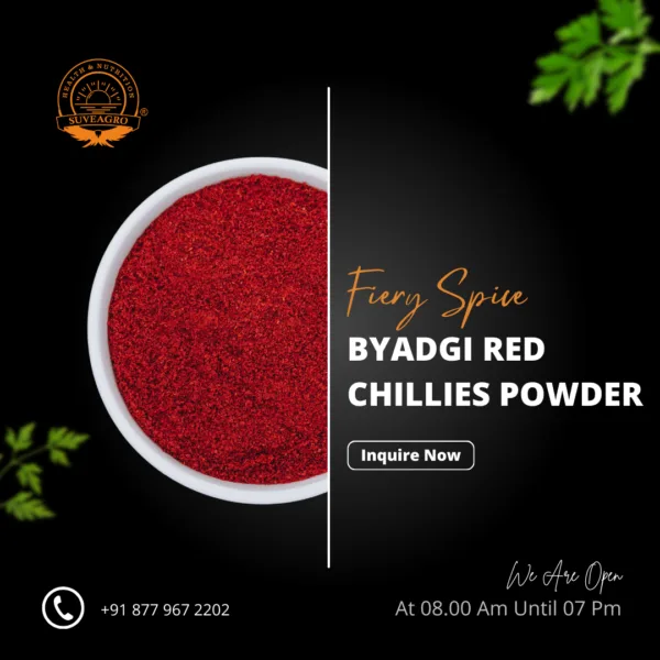 Byadagi Red Chillies Powder in a wooden bowl with red chilies around.